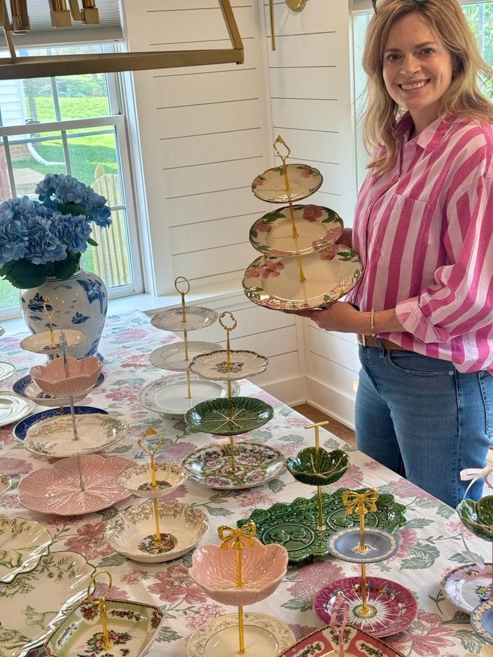 Jennifer Sheppard holding a handcrafted three-tiered stand
