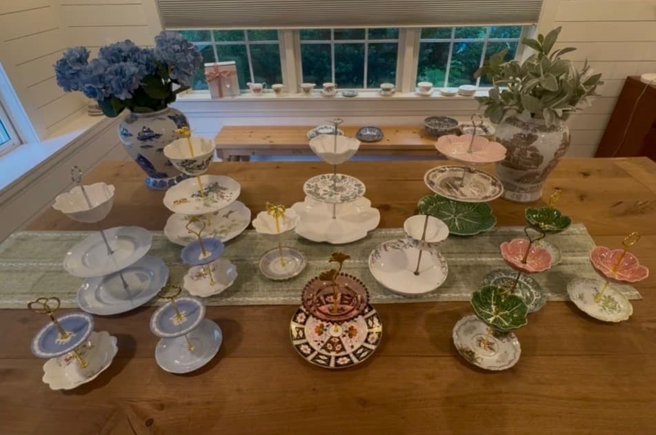 Assortment of handcrafted tiered china stands on a wooden table