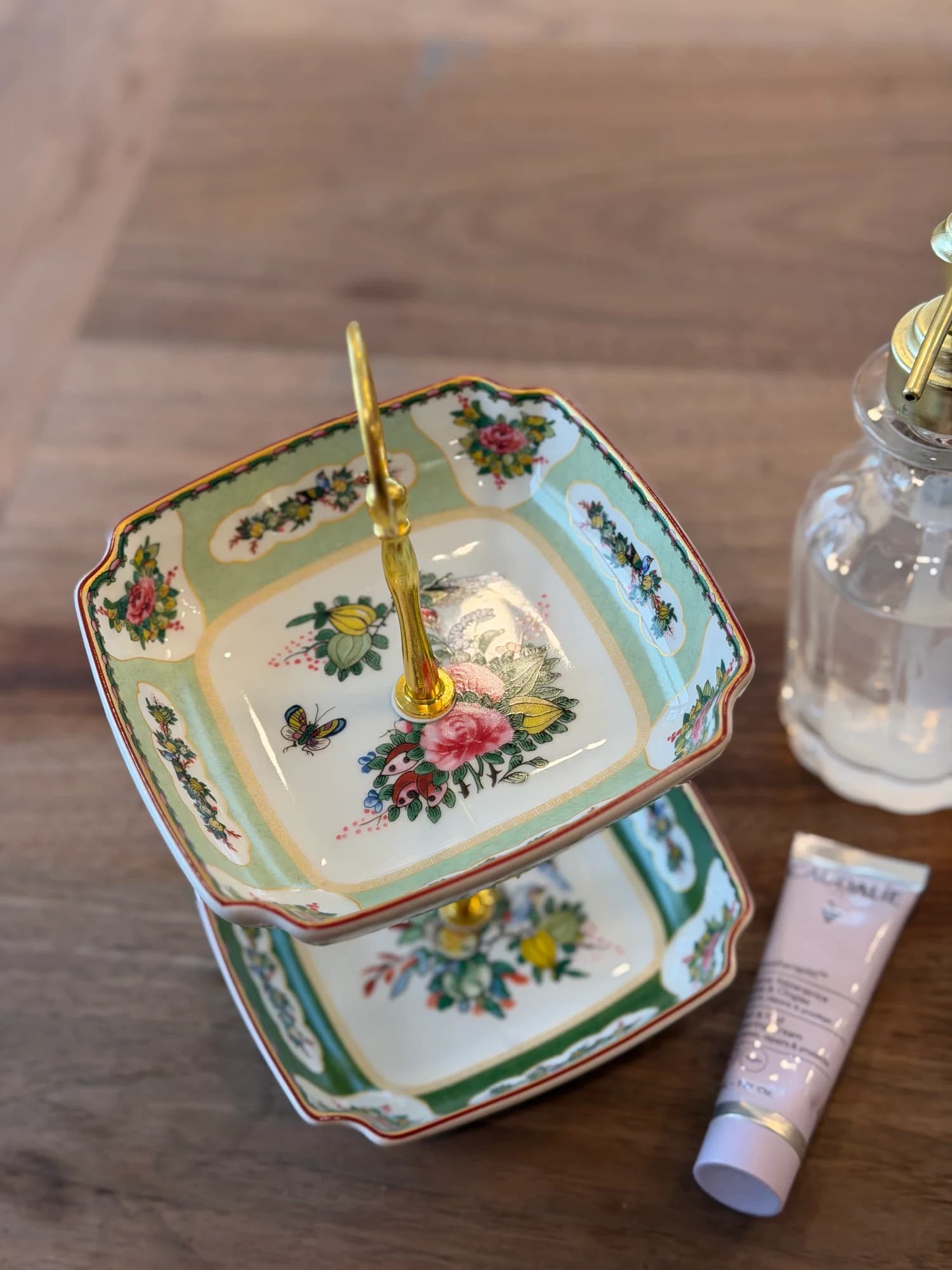 This petite Famille Rose tiered stand celebrates the…