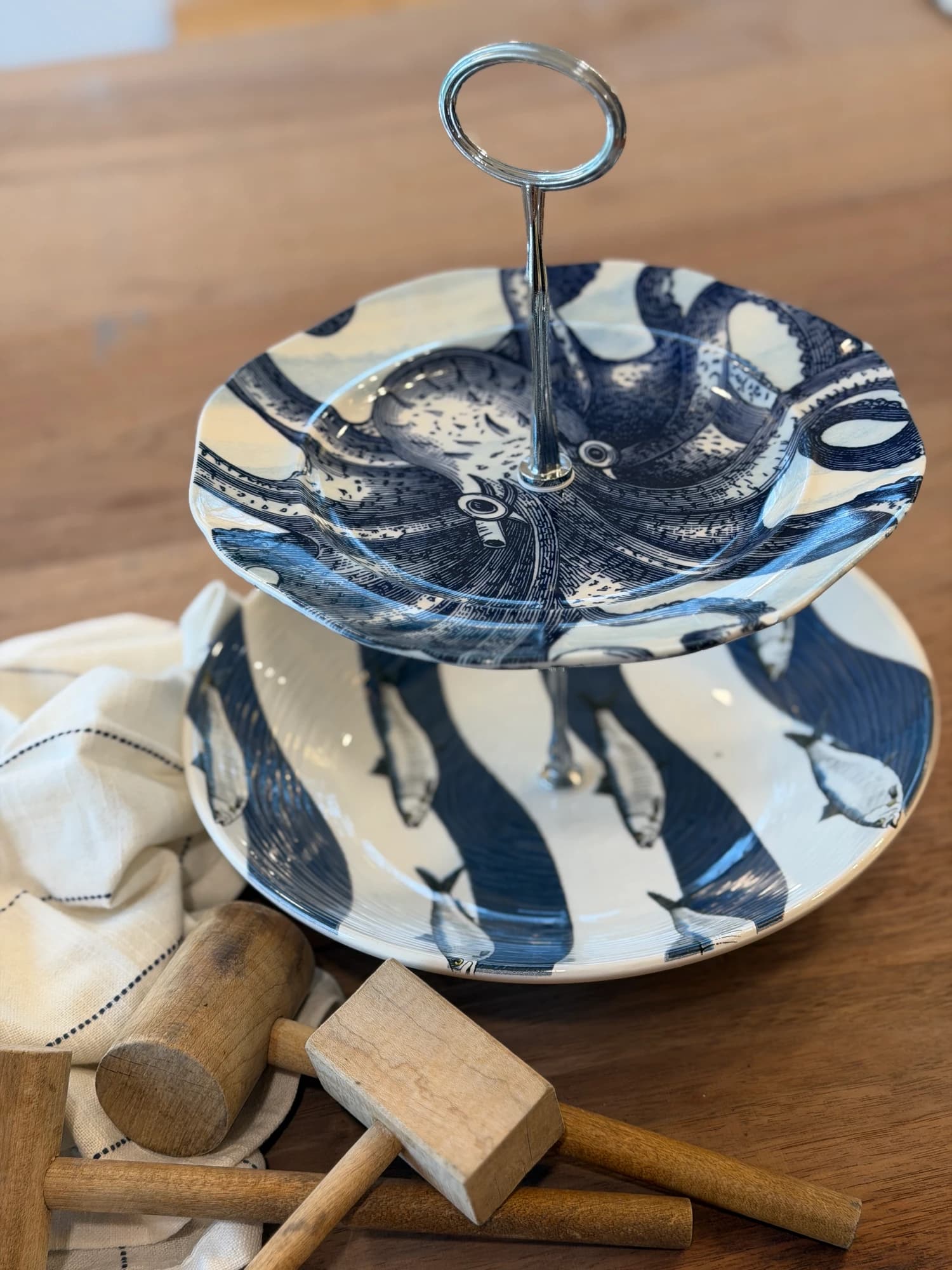 Anthropologie octopus plate atop a Ceramica Italia sardine…