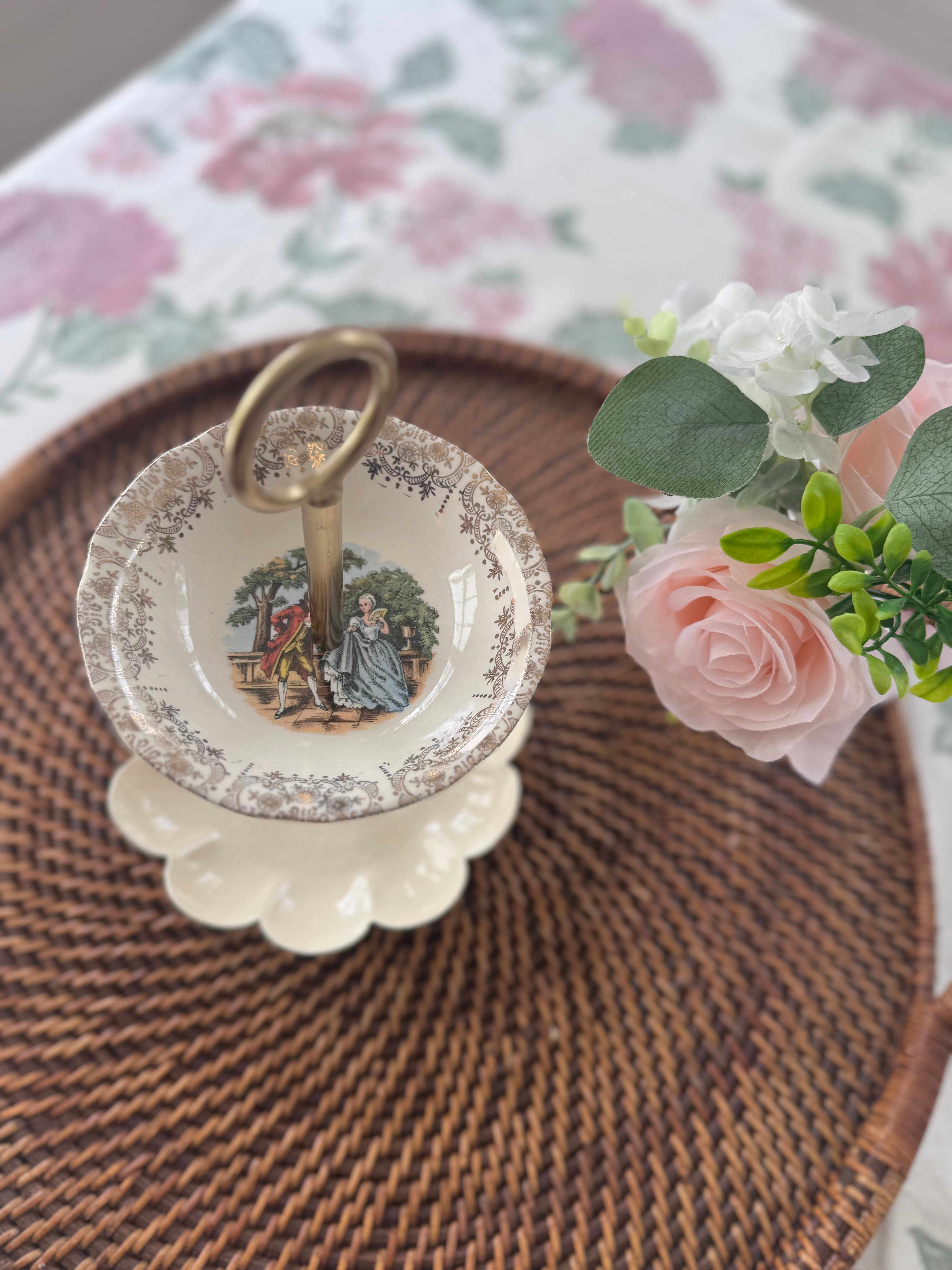 Petite jewelry stand with metal scalloped bases topped with…